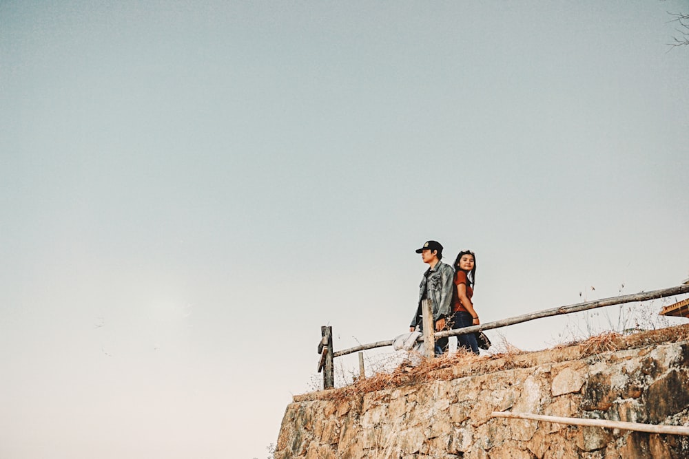 couple standing under white clouds