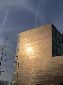 Finished building gleaming in the sunlight, symbolizing timely completion and quality.