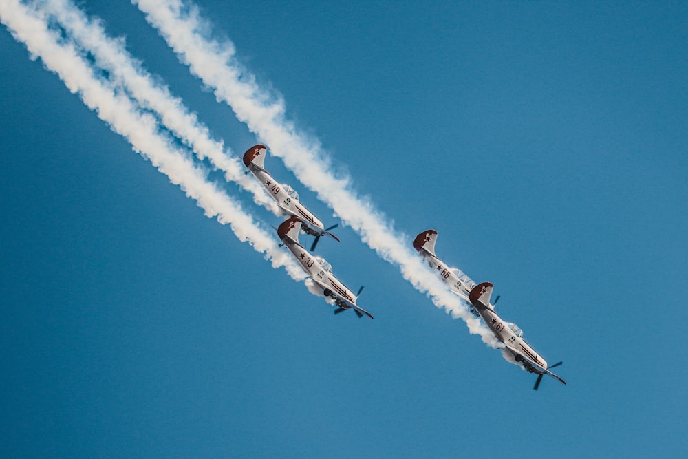 four airplanes flying on sky during daytime