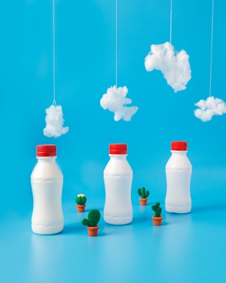 three white plastic bottles under white cottons