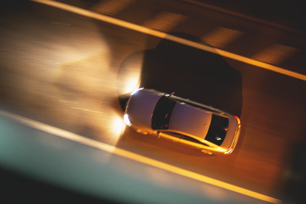 white car in motion during night time