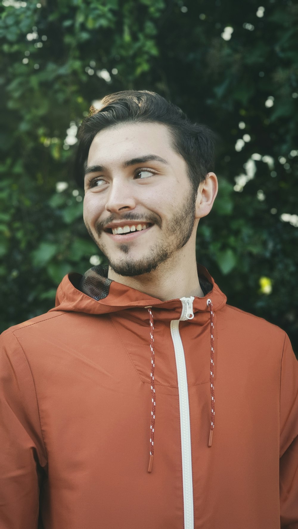 man in red hoodie smiling