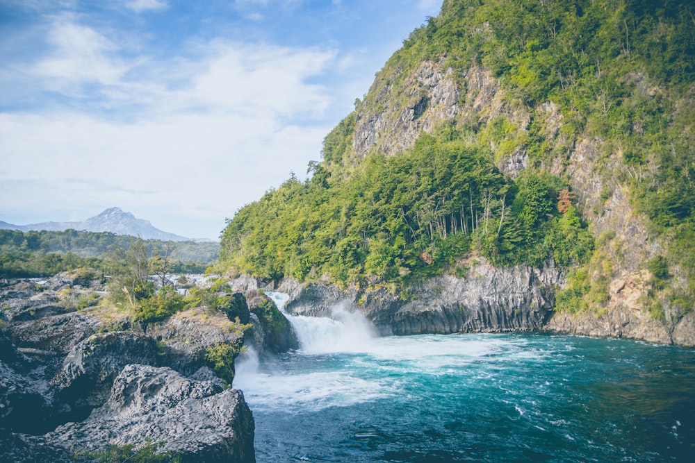 river near mountain at daytime