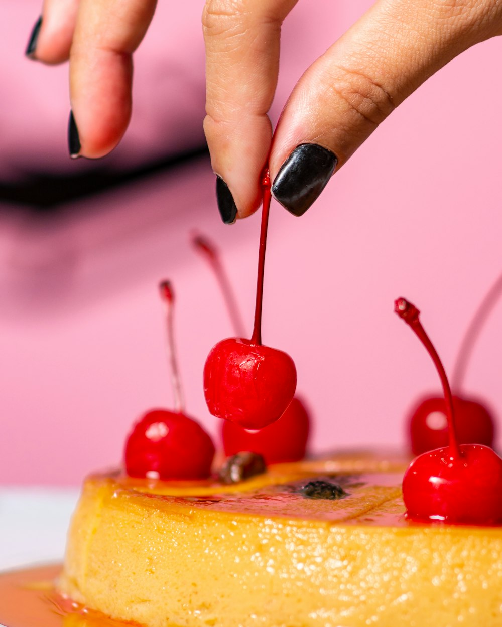 person holding red cherry