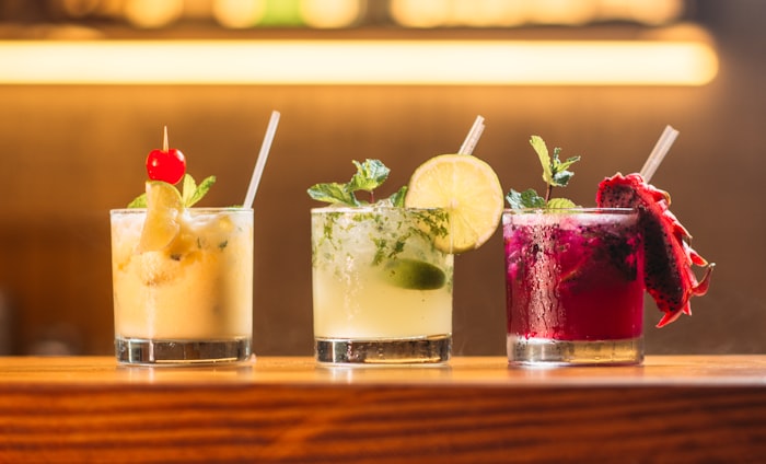 Colourful fruit cocktails and cordials on bar counter