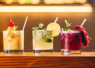 three clear glass cups with juice