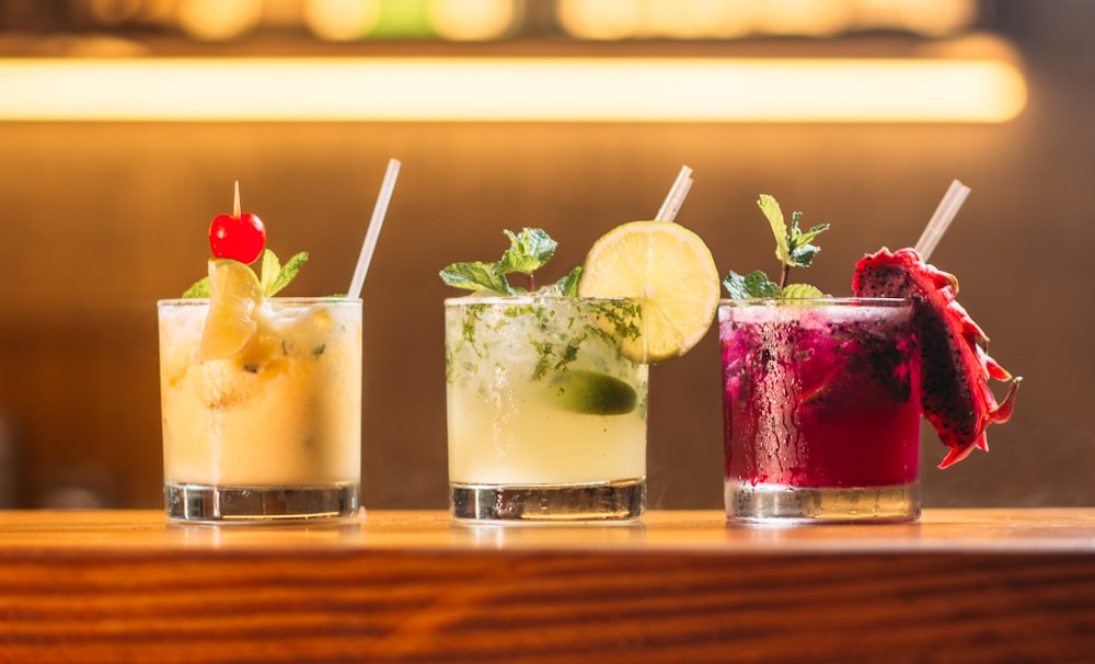 three clear glass cups with juice