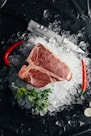 raw meat on ice with coriander and chilis
