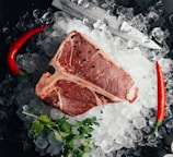 raw meat on ice with coriander and chilis