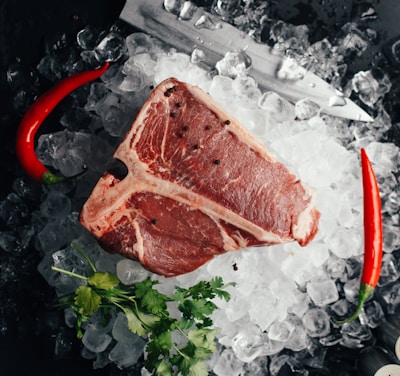 raw meat on ice with coriander and chilis