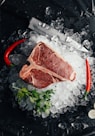 raw meat on ice with coriander and chilis