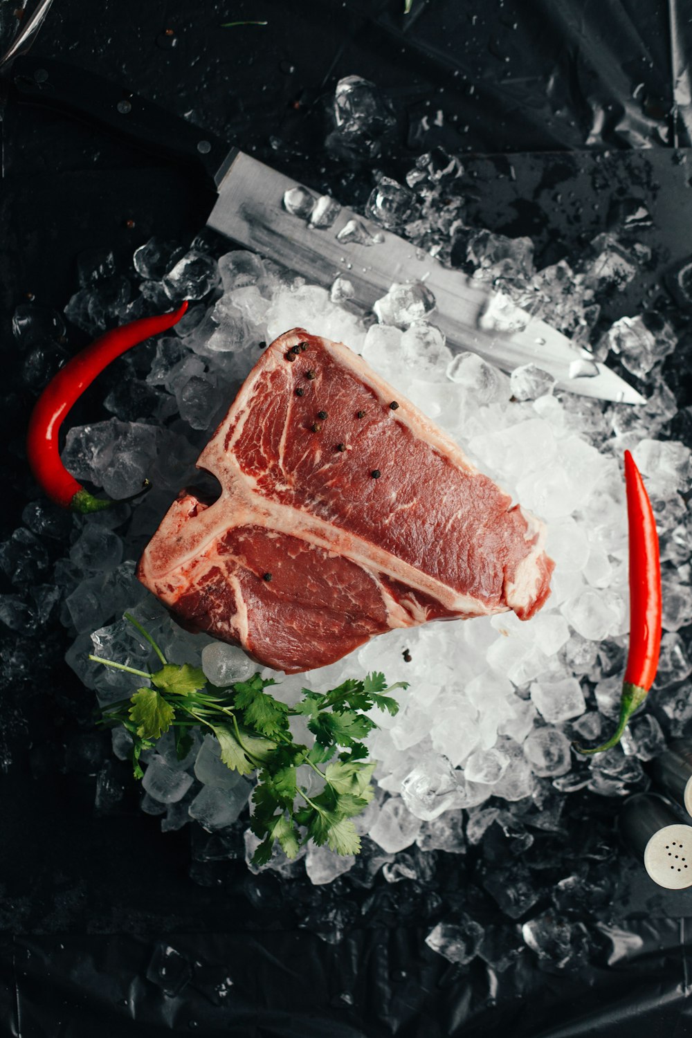 raw meat on ice with coriander and chilis