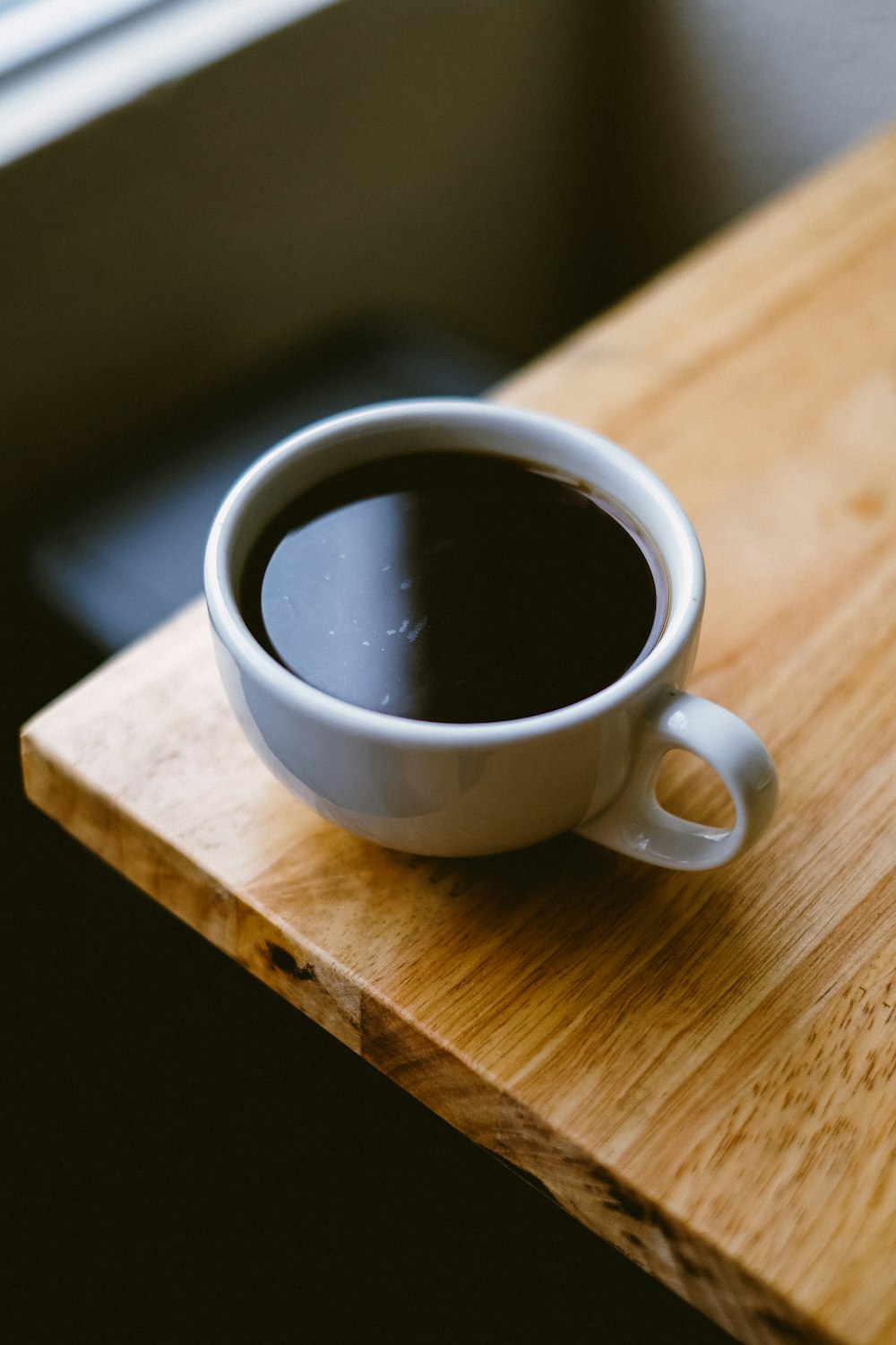 white coffee cup on brown wooden table