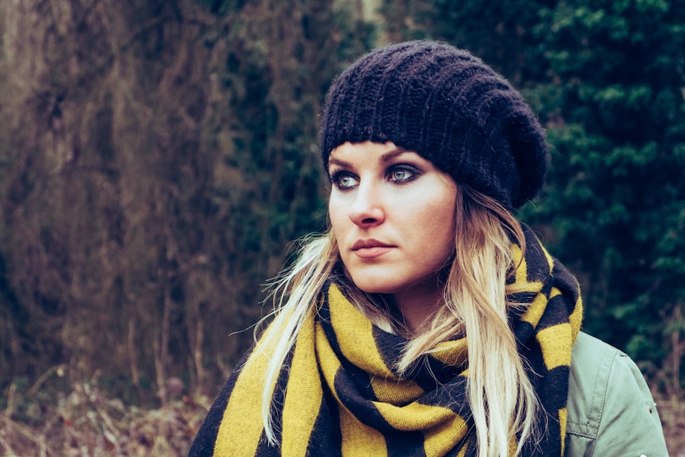 woman wearing black knit hat near trees