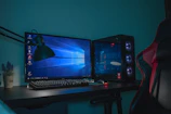turned on desktop computer set with black and gray leather gaming chair