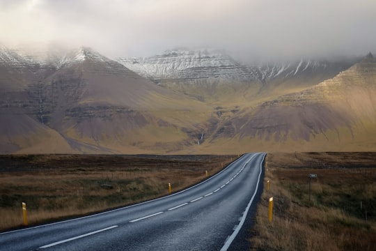 gray concrete road and brown mountains during daytime in Snæfellsnesvegur Iceland