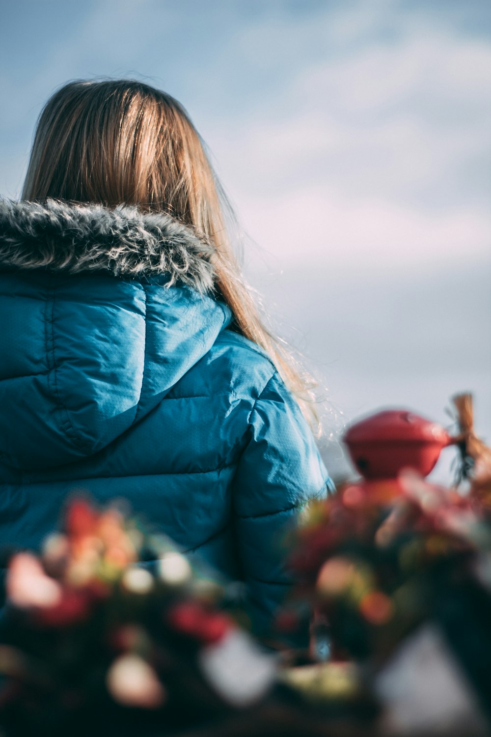 woman in blue hooded bubble jacket