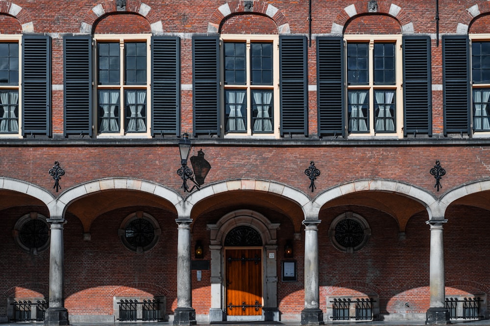 brown brick building with lamp on wall