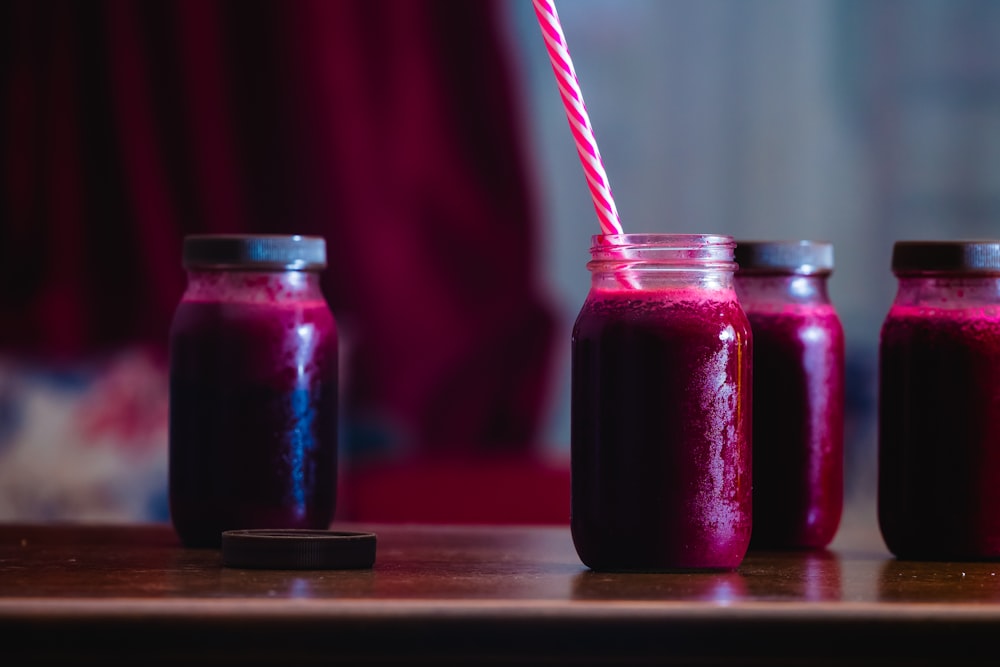 red beverage in mason jars