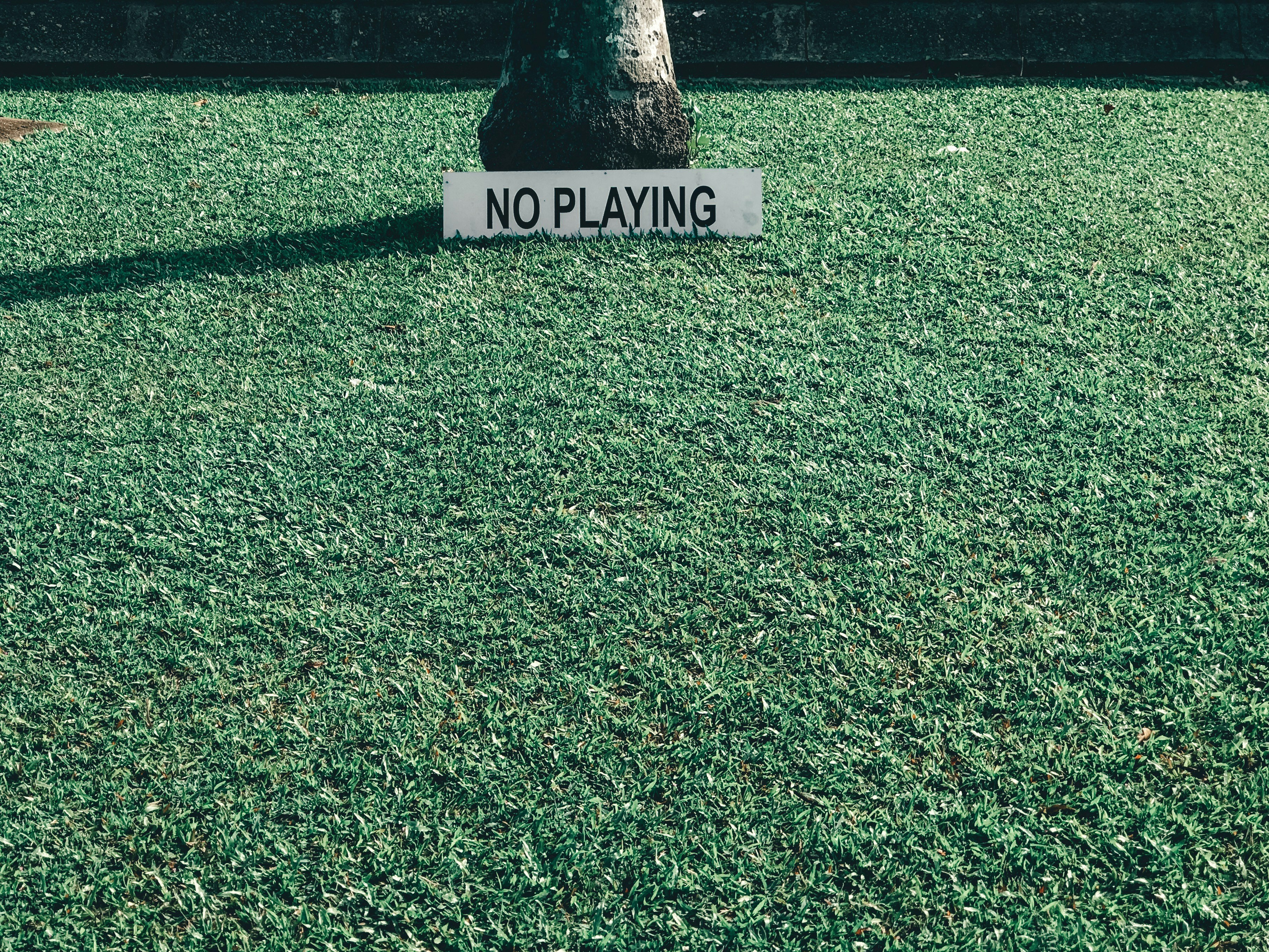 no playing sign on grass field