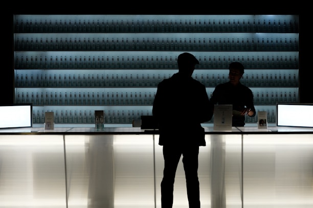 silhouette of man standing near glass counter top