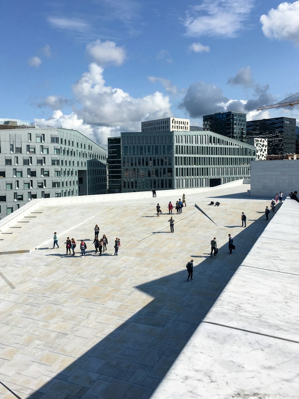 people outside gray concrete buildings