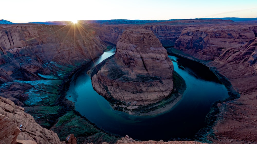 lake surrounded by brown rock formation