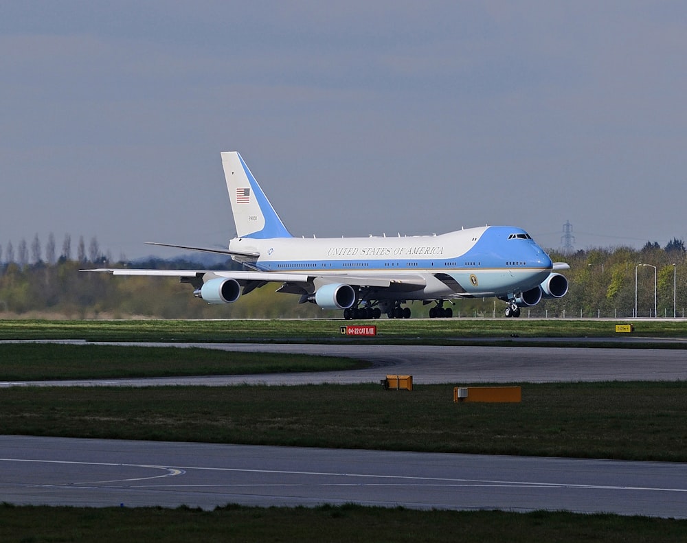 white and blue airplane during daytime