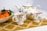 white-and-multicolored mugs filled with tea beside fruits