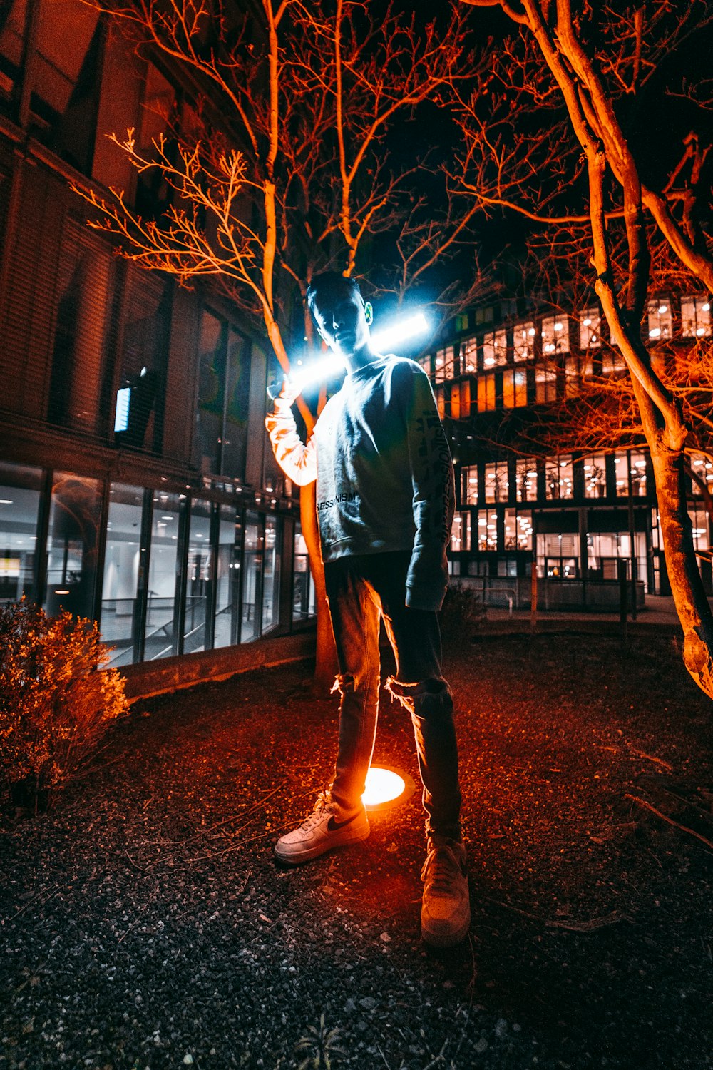 man standing behind of red LED light