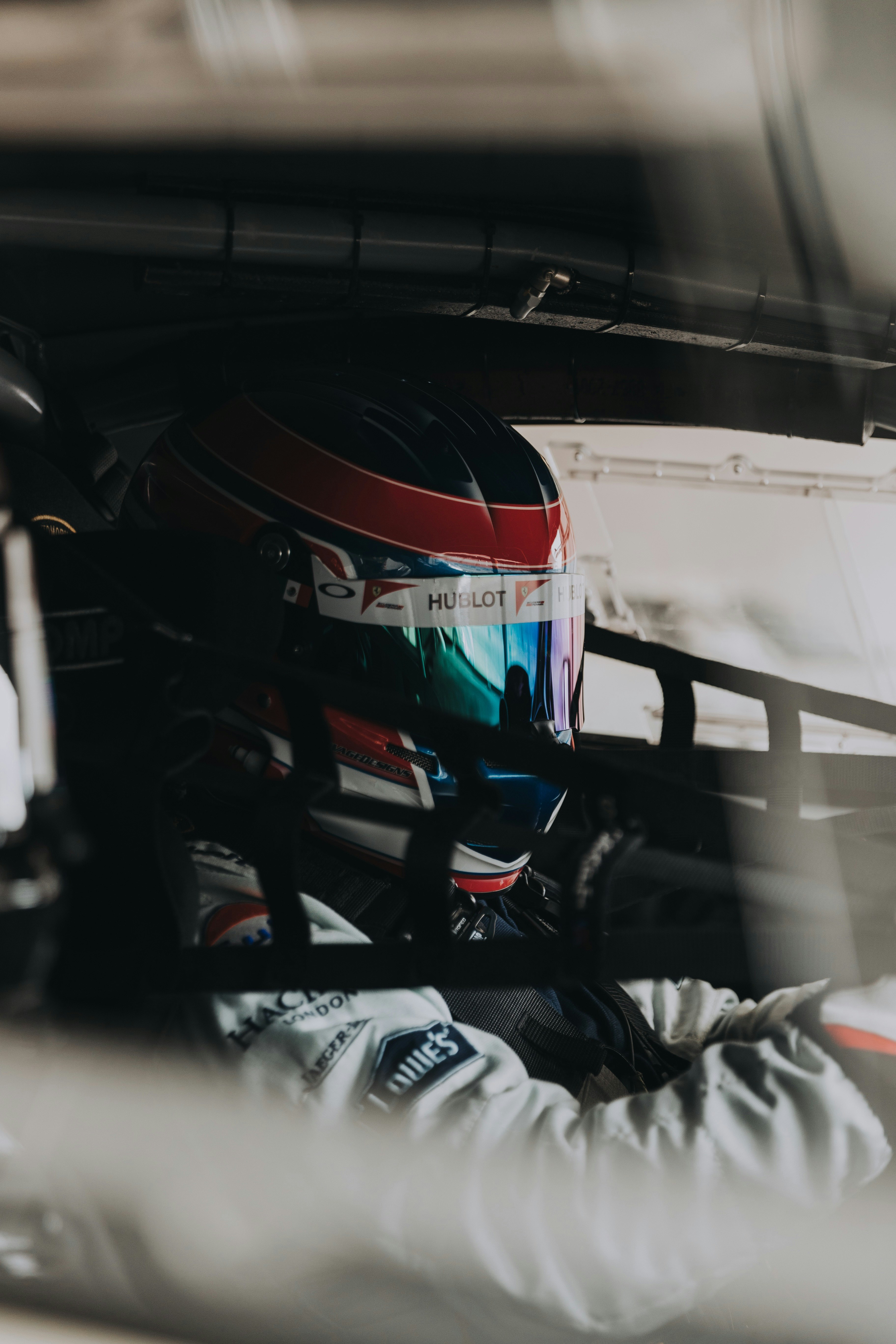 selective focus photography of driver inside sports car with rollcage during daytime
