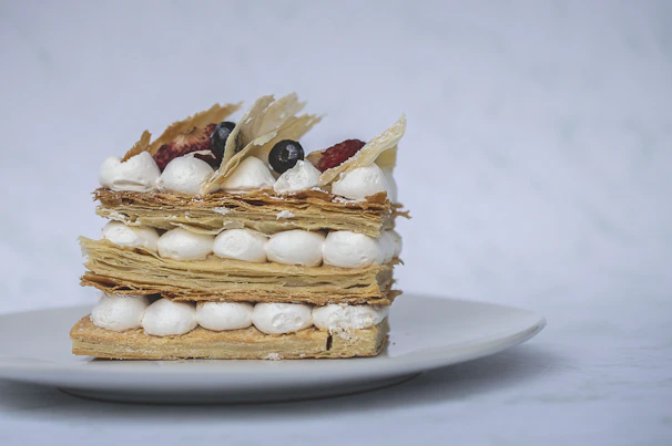 A delicate mille-feuille pastry with crisp layers and creamy filling dusted with powdered sugar