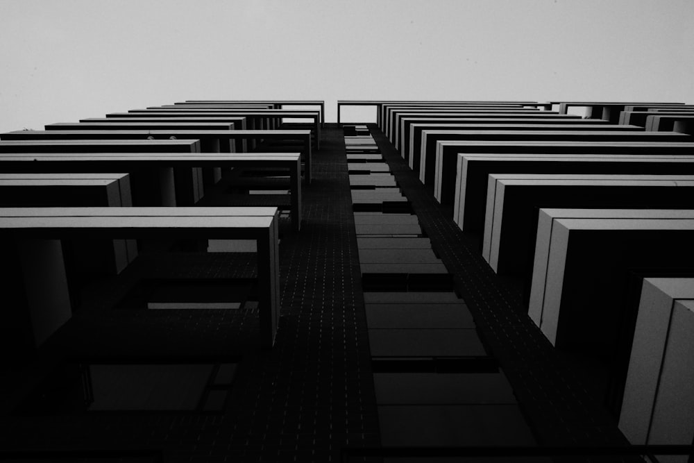 a black and white photo of rows of desks