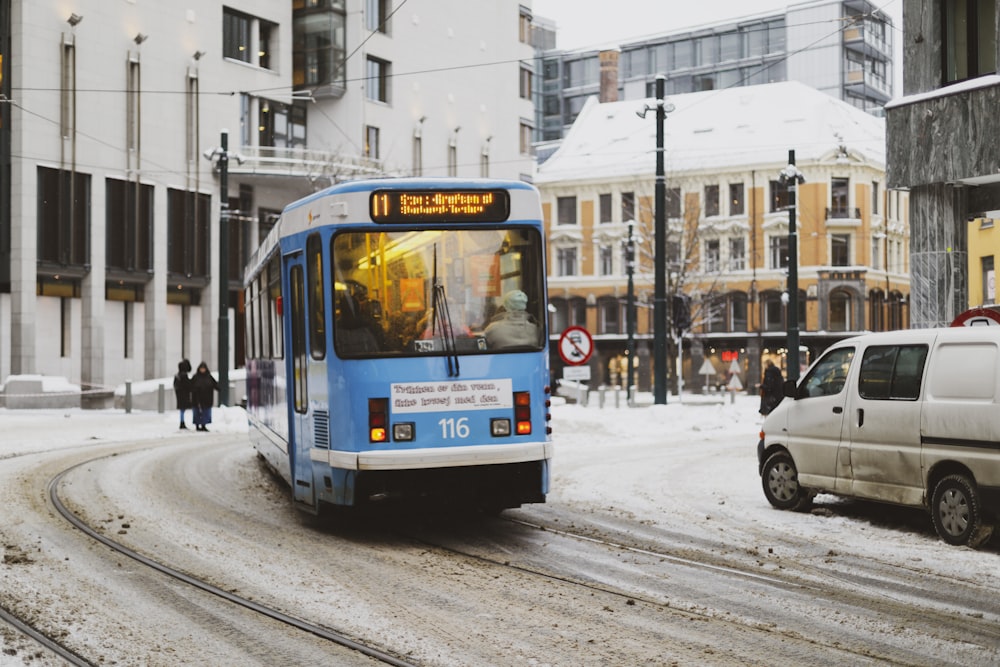 blue bus passing through building