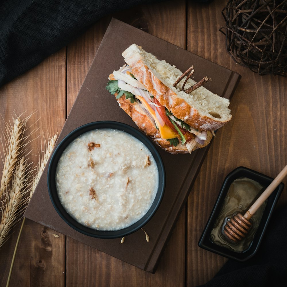 bread and soup on top of brown book