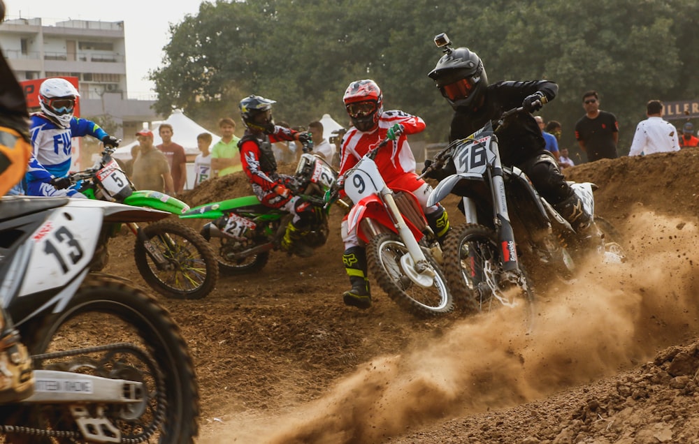 four men riding dirt bikes