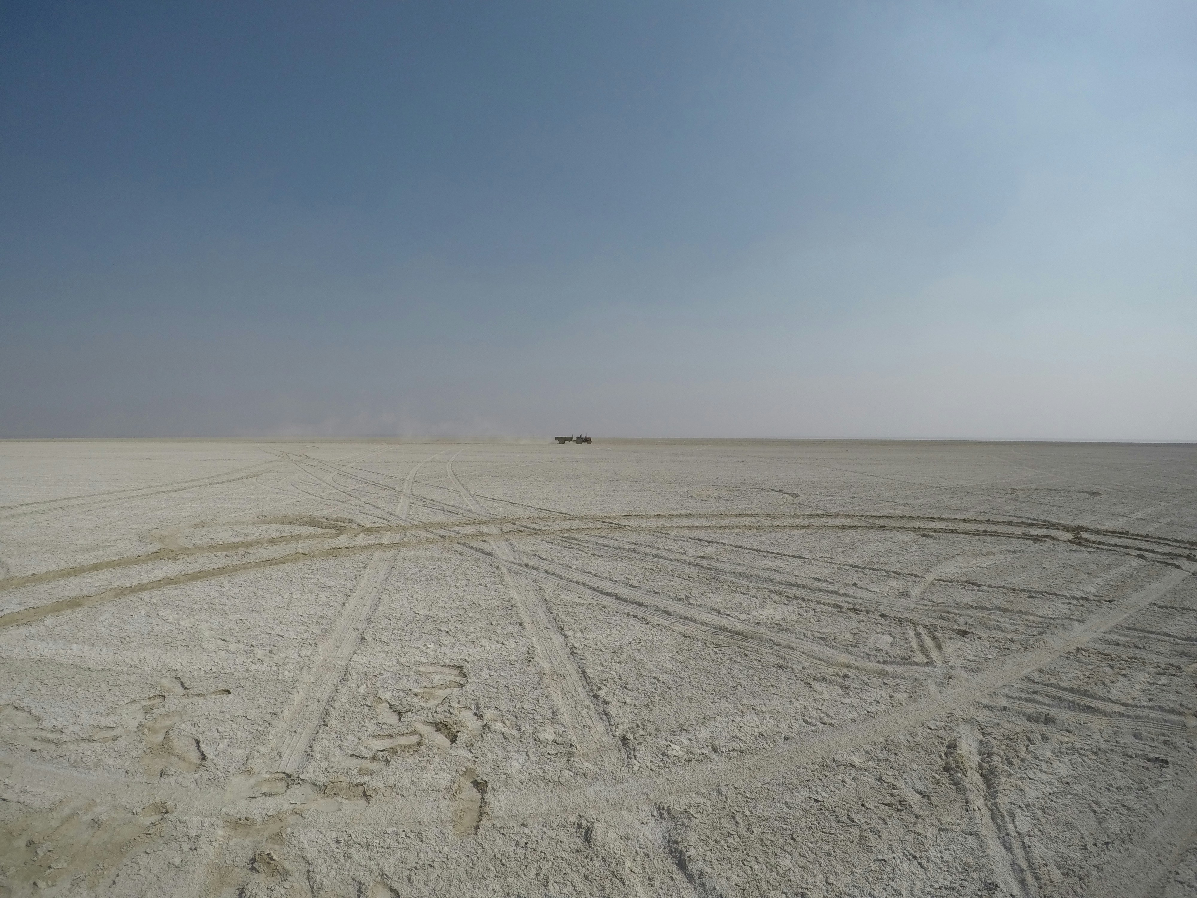 vehicle tracks all over the sand during daytime