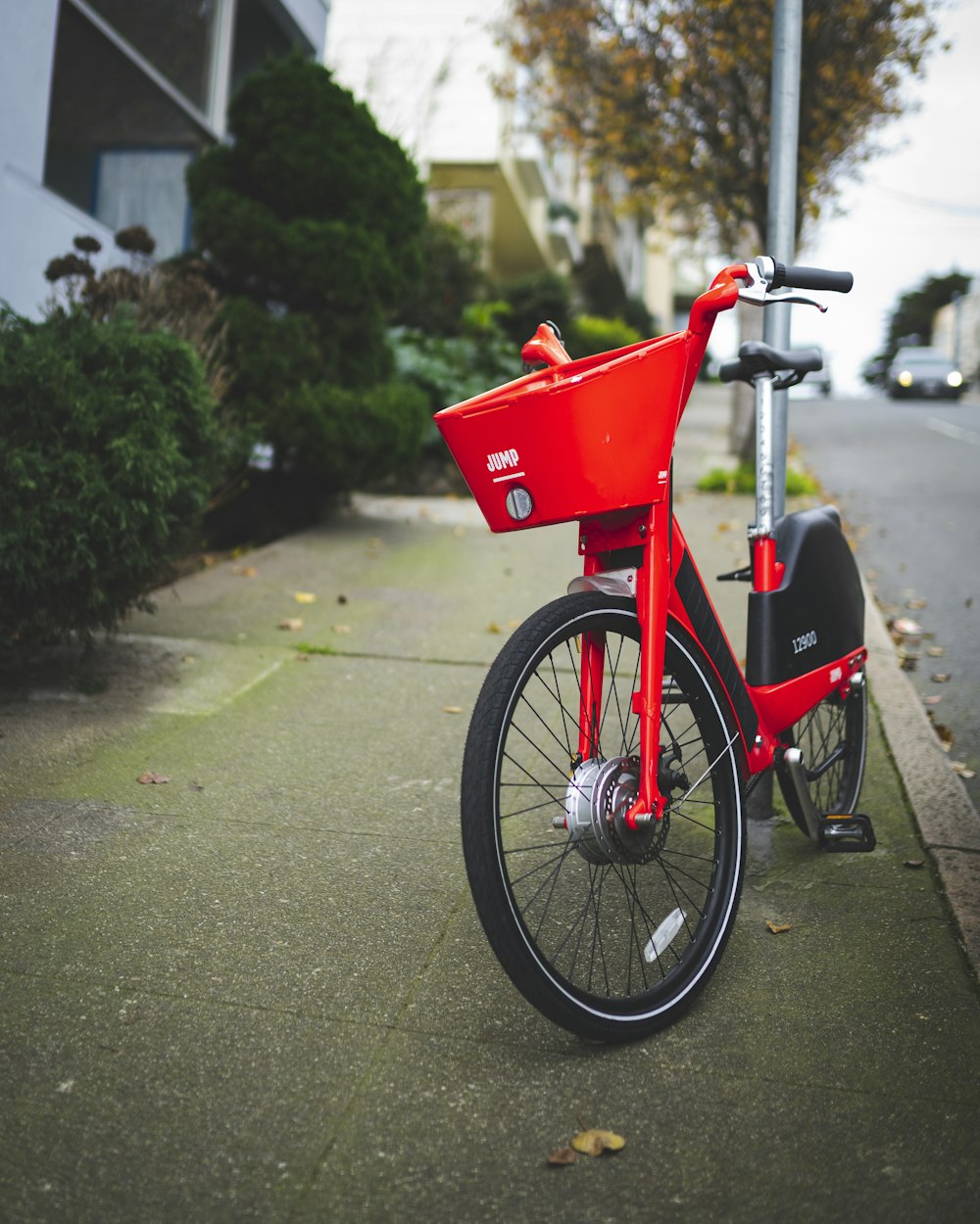 red and black city bike on asphalt road