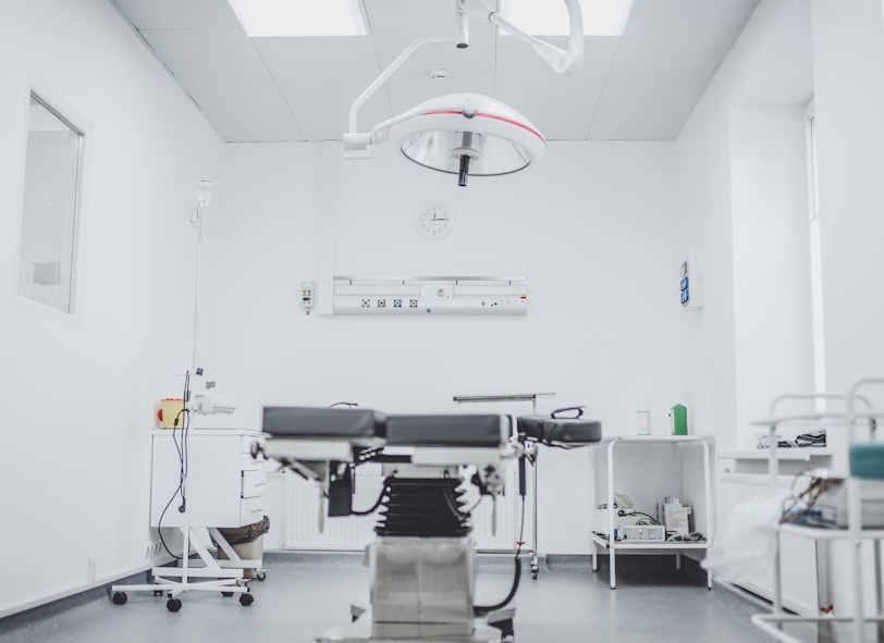 black and white hospital bed in the middle of interior building