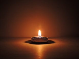 round ceramic bowl with lighted candle
