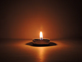 round ceramic bowl with lighted candle