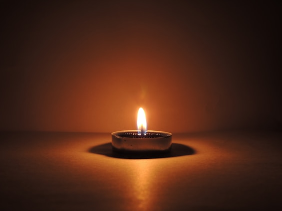 round ceramic bowl with lighted candle