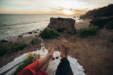 person lying on white textile beside beach