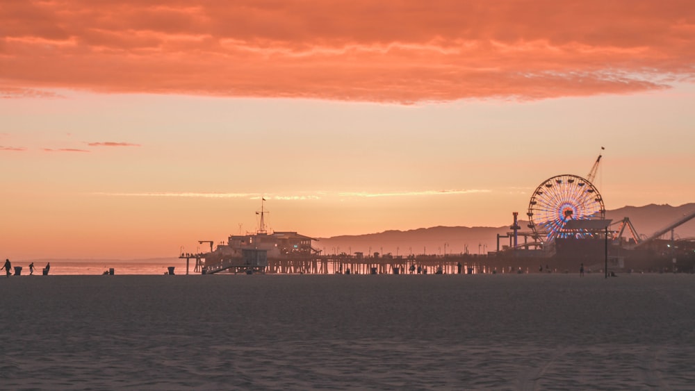 brown ferris wheel under orange cloudy sky