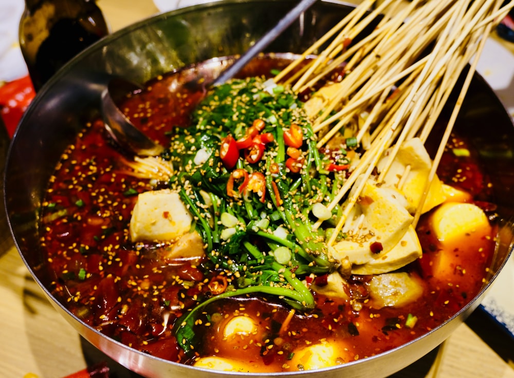 noodles and vegetables cooked on cooking pot