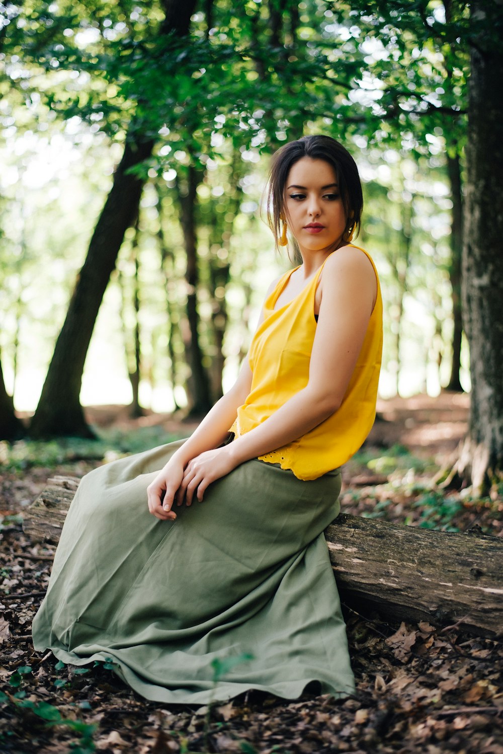 woman sitting on brown dry leaves