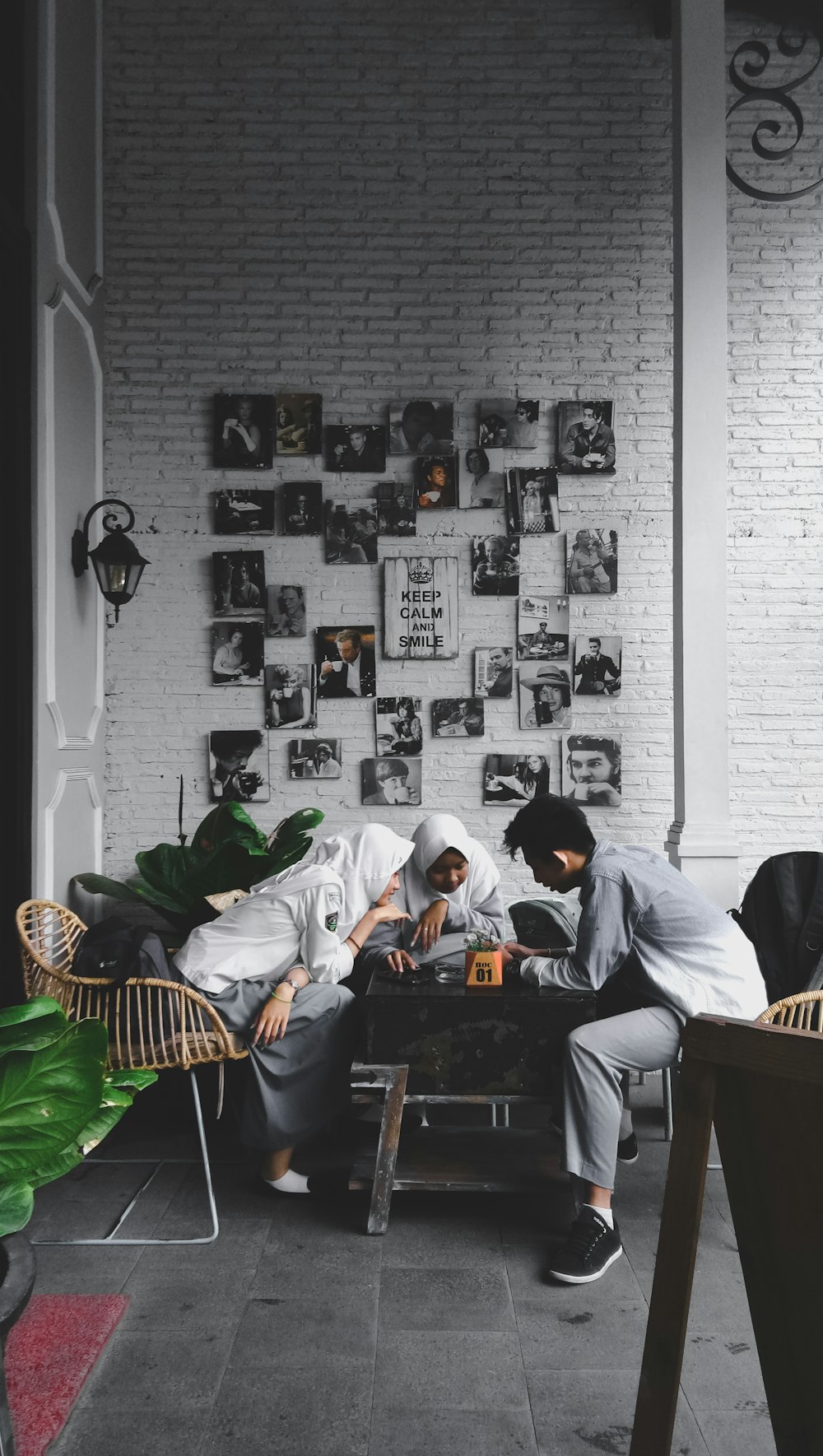 three person sitting on sofa set