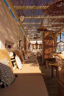 An inviting outdoor seating area with colorful cushions and ambient evening lighting.