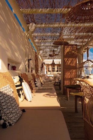 Inviting outdoor seating area with colorful cushions and fairy lights around the cabin.