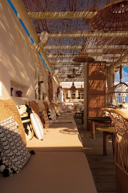 Cozy outdoor lounge area with soft cushions and ambient lighting at dusk